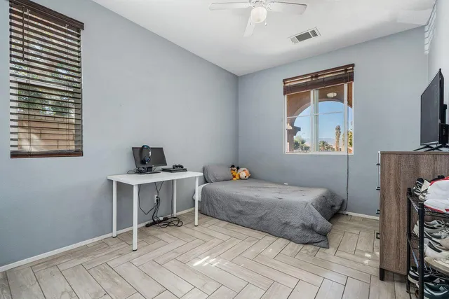 a bedroom with a bed and a tv on table