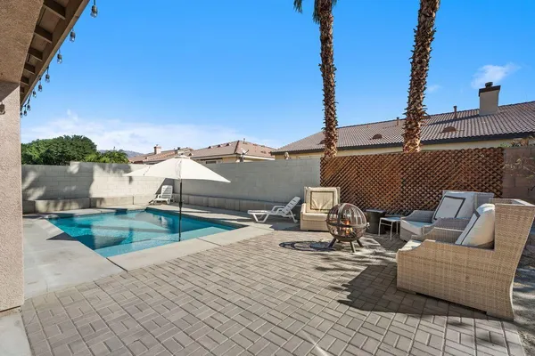 a view of roof deck with couch and chairs