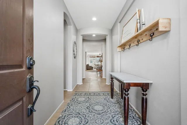 a view of hallway with stairs and wooden floor