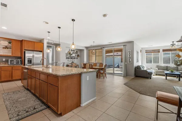 a large kitchen with kitchen island granite countertop a large counter top and living room