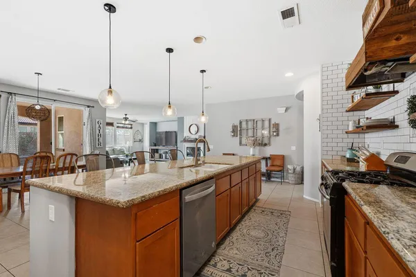 a kitchen with sink stove and cabinets