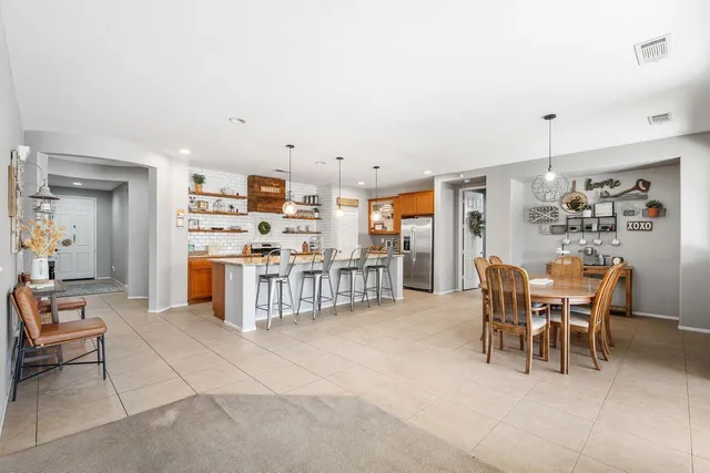 a kitchen with stainless steel appliances kitchen island granite countertop a sink and cabinets