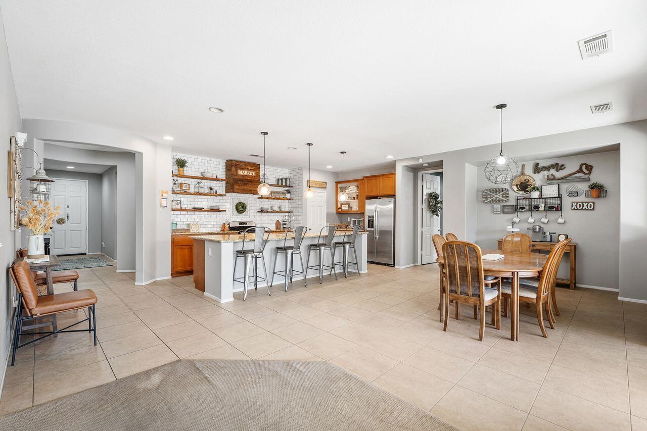 42724 Tango Court Indio, CA 92203 - Photo 9 of 27 a kitchen with stainless steel appliances kitchen island granite countertop a sink and cabinets