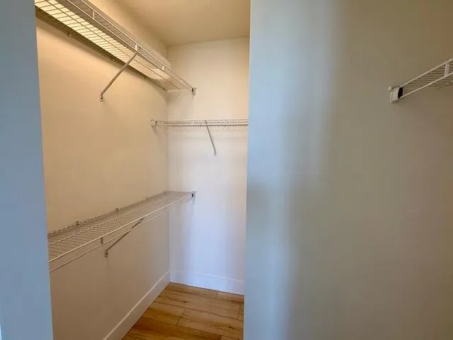 a bathroom with a granite countertop bathtub shower and toilet