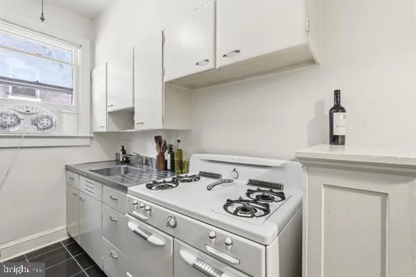 a kitchen with a stove and cabinets