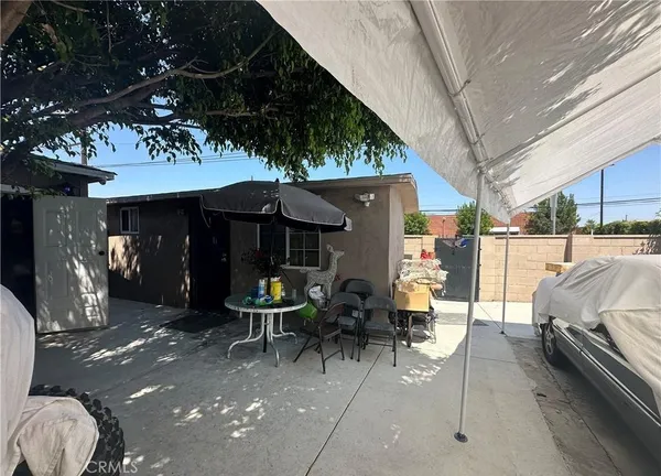 a view of a patio with table and chairs and potted plants
