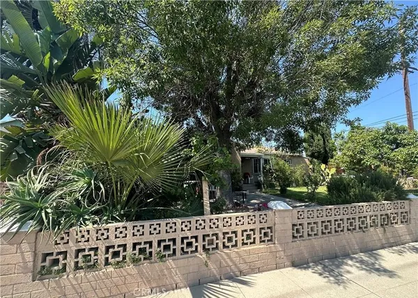 a view of a wooden fence and trees