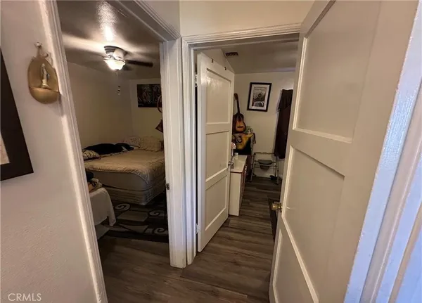 a view of a hallway with wooden floor and stairs