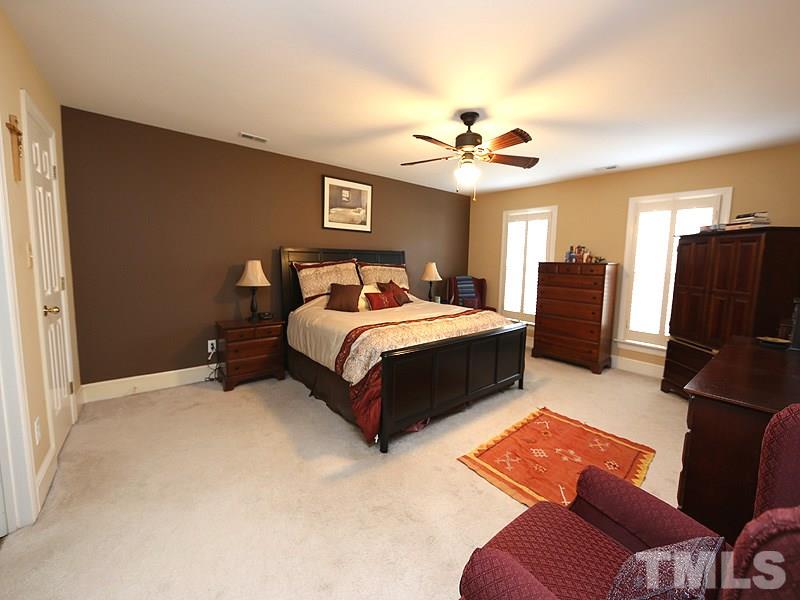 8208 Mourning Dove Road Raleigh, NC 27615 - Photo 12 of 25 a bedroom with a bed dresser and a window