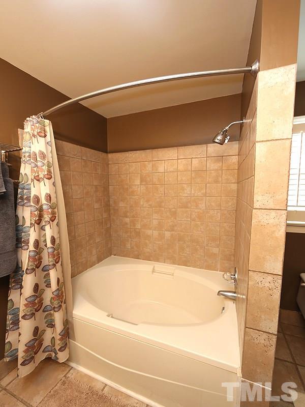 8208 Mourning Dove Road Raleigh, NC 27615 - Photo 14 of 25 a bathroom with a bathtub and a shower