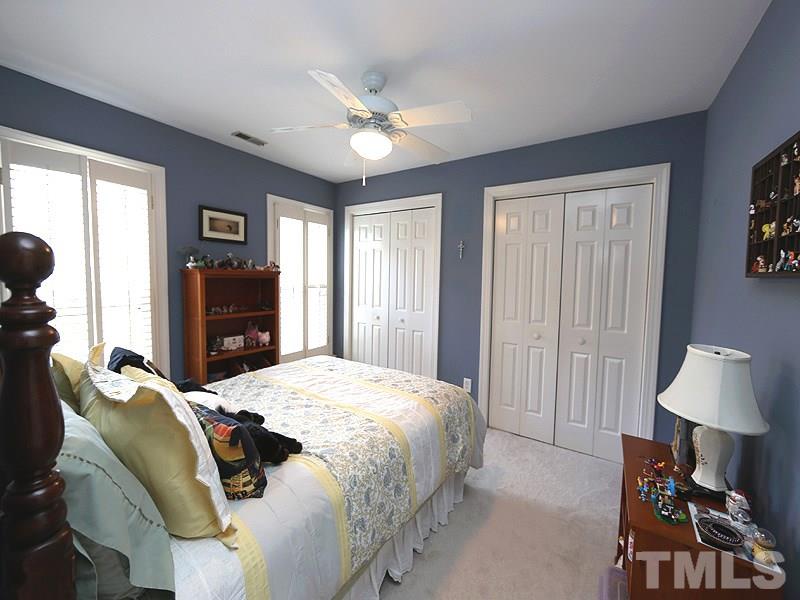 8208 Mourning Dove Road Raleigh, NC 27615 - Photo 15 of 25 a spacious bedroom with a bed and wooden floor