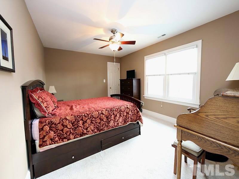 8208 Mourning Dove Road Raleigh, NC 27615 - Photo 16 of 25 a bedroom with a bed window and couch