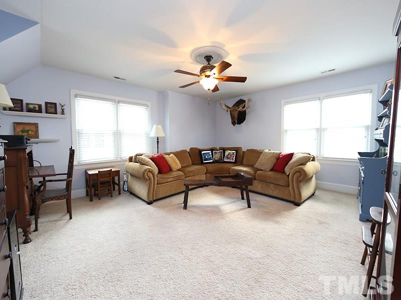 8208 Mourning Dove Road Raleigh, NC 27615 - Photo 18 of 25 a living room with furniture a ceiling fan and a window