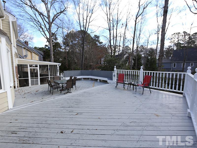 8208 Mourning Dove Road Raleigh, NC 27615 - Photo 22 of 25 a view of roof deck with table and chairs and wooden floor