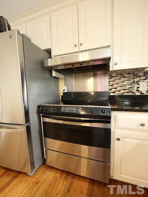 8208 Mourning Dove Road Raleigh, NC 27615 - Photo 25 of 25 a stove top oven sitting inside of a kitchen