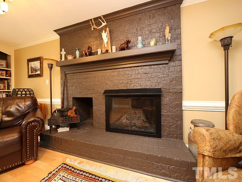 8208 Mourning Dove Road Raleigh, NC 27615 - Photo 6 of 25 a living room with furniture and a fireplace