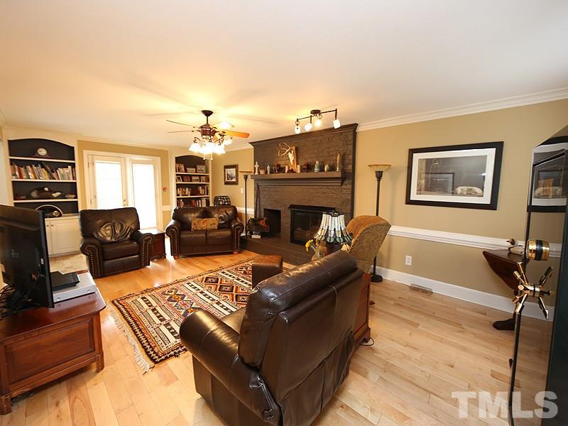 8208 Mourning Dove Road Raleigh, NC 27615 - Photo 7 of 25 a living room with furniture fireplace and flat screen tv