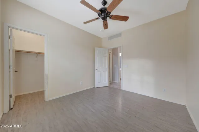 a view of a livingroom with a ceiling fan and wooden floor