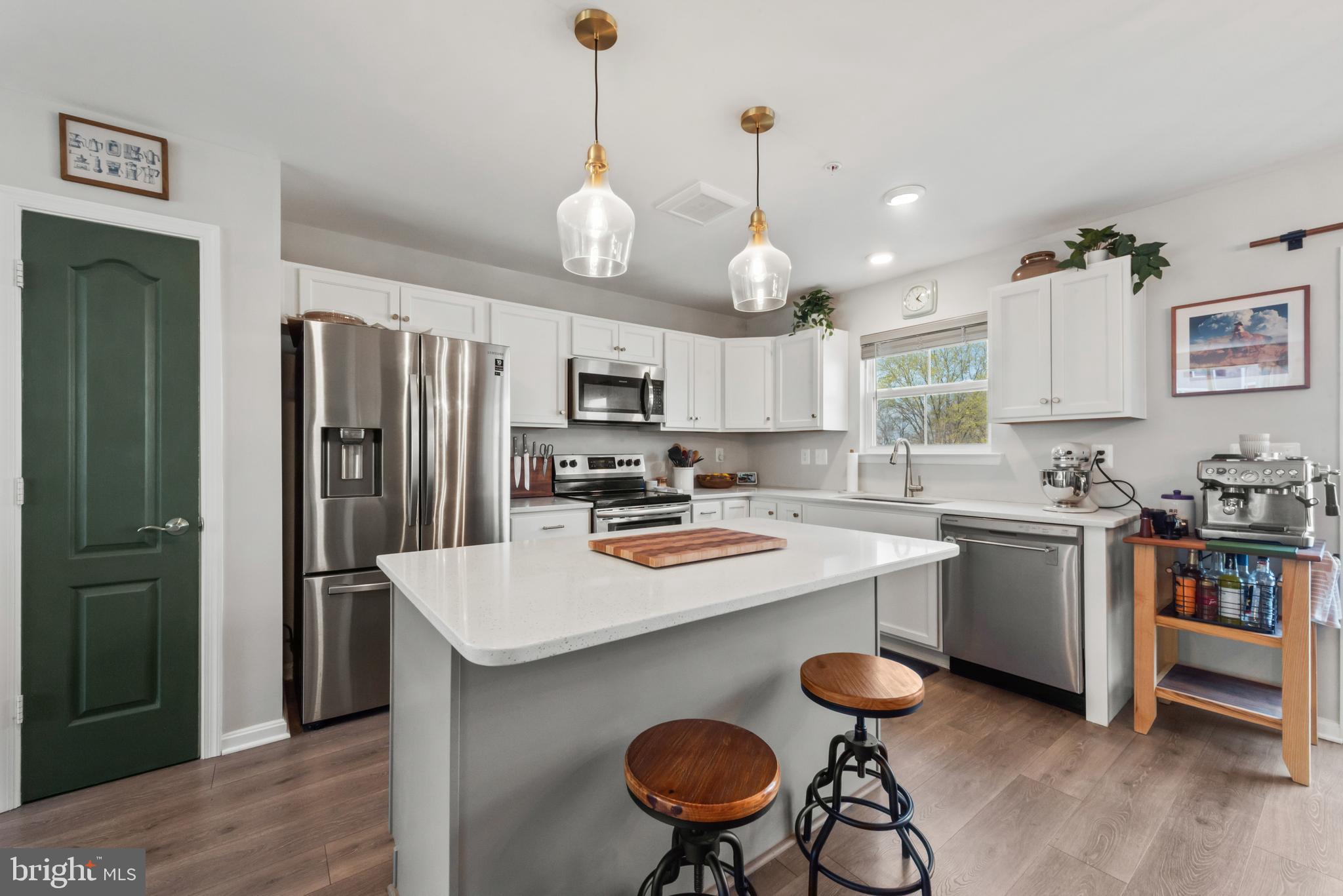 61 Grant Street Taneytown, MD 21787 - Photo 12 of 34 a kitchen with sink cabinets stainless steel appliances and chair