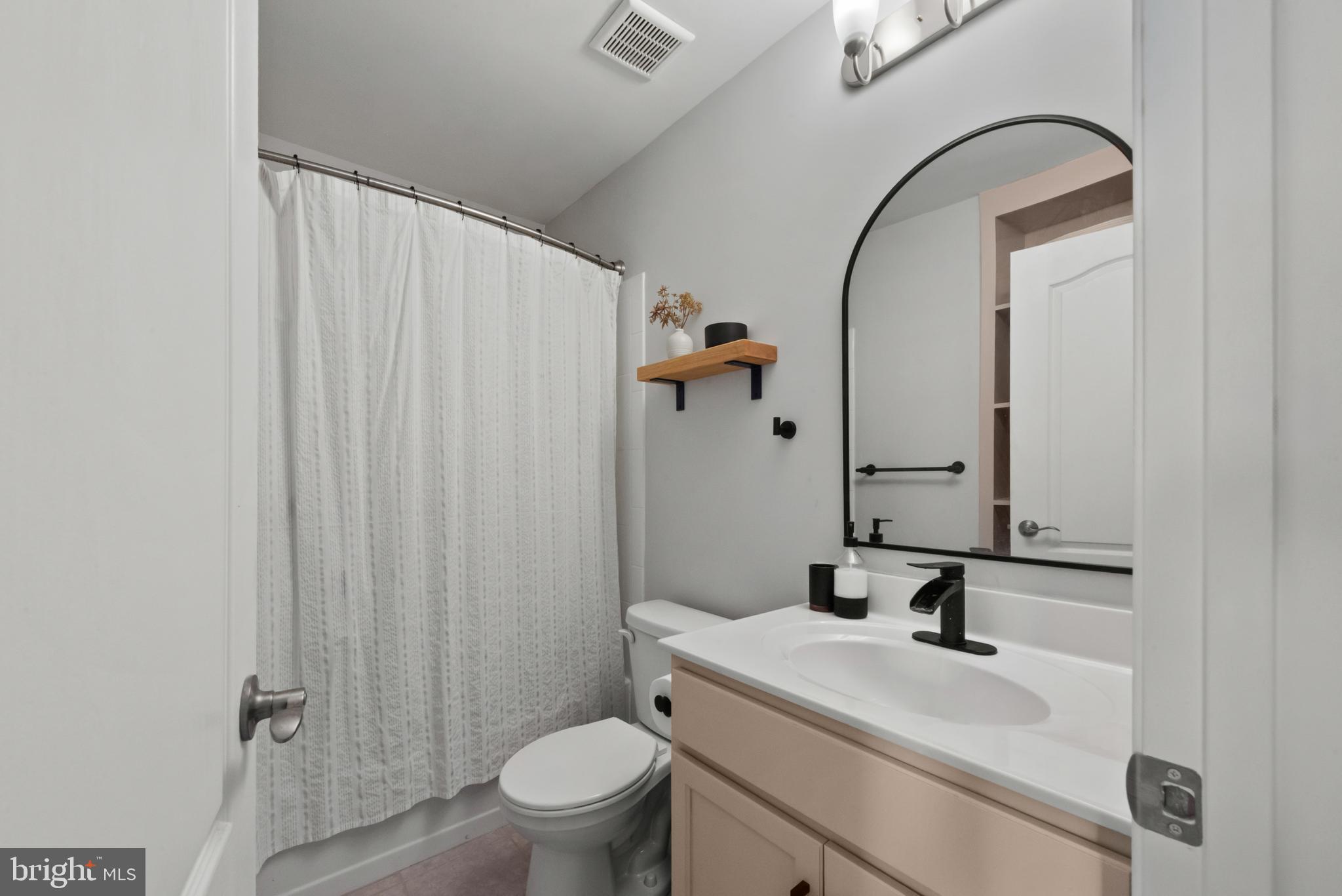 61 Grant Street Taneytown, MD 21787 - Photo 24 of 34 a bathroom with a sink a toilet and shower