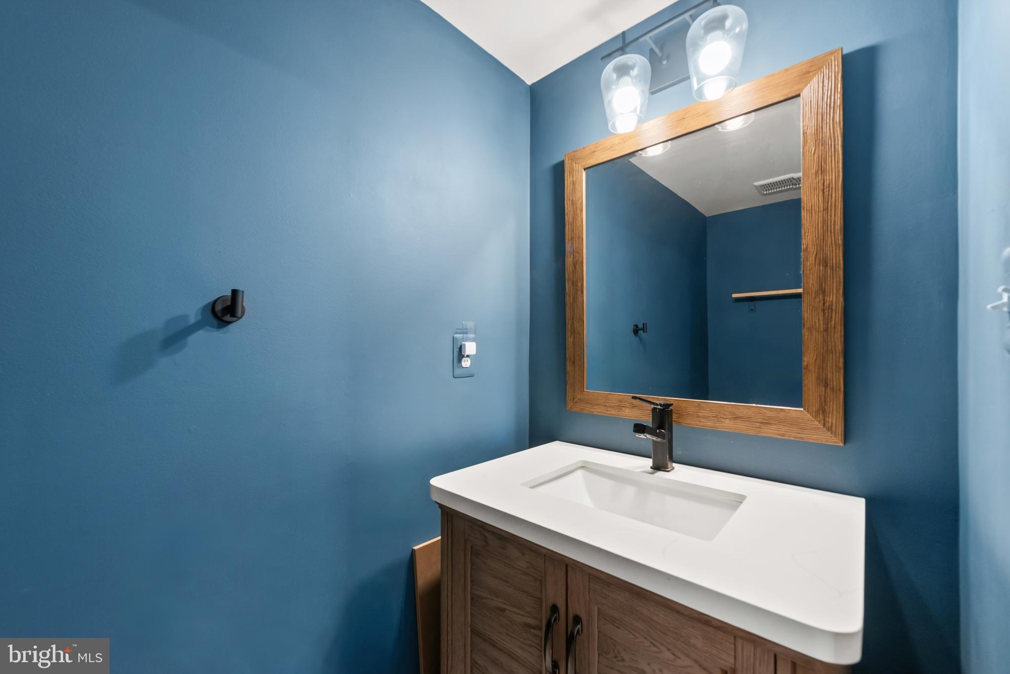 61 Grant Street Taneytown, MD 21787 - Photo 7 of 34 a bathroom with a sink and a mirror