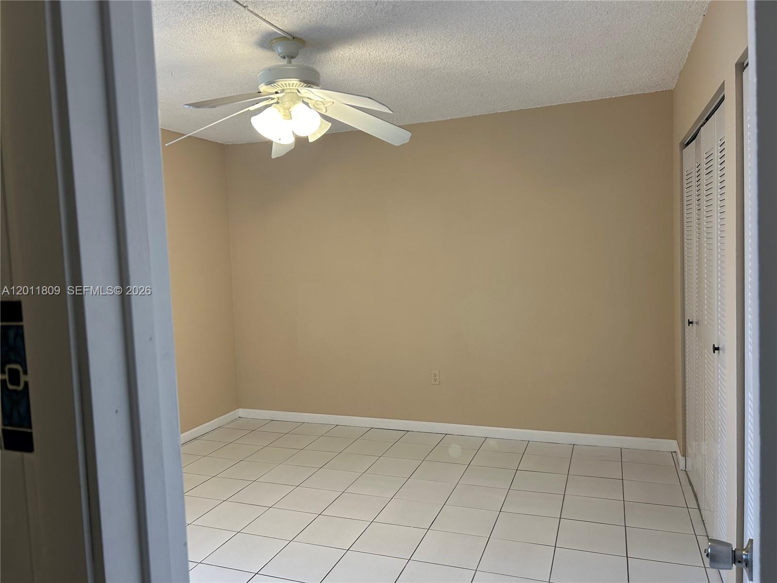 9411 Southwest 4th Street, Unit 202 Miami, FL 33174 - Photo 4 of 20 a view of an empty room and chandelier fan