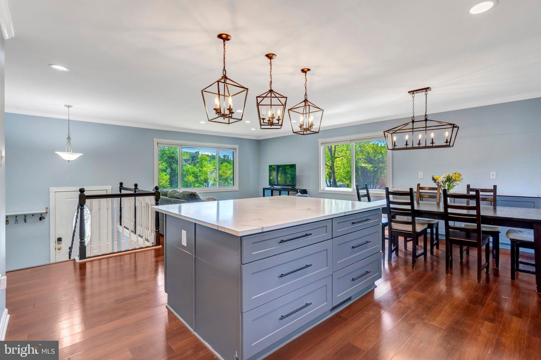 7212 Galgate Drive Springfield, VA 22153 - Photo 6 of 39 a kitchen with stainless steel appliances granite countertop kitchen island a table and chairs in it