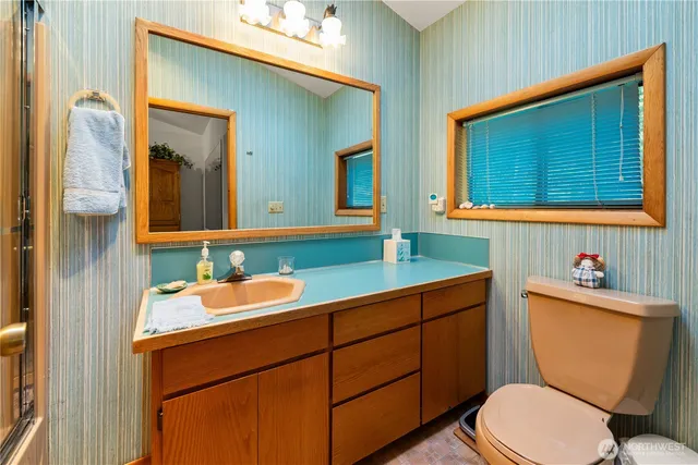 a bathroom with a toilet sink and mirror