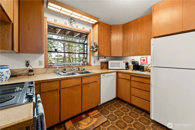 a kitchen with stainless steel appliances a stove a sink and a refrigerator