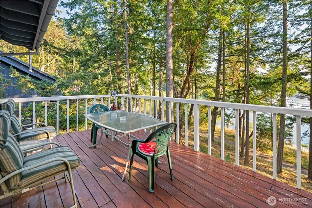 a view of a deck with two chair and wooden floor