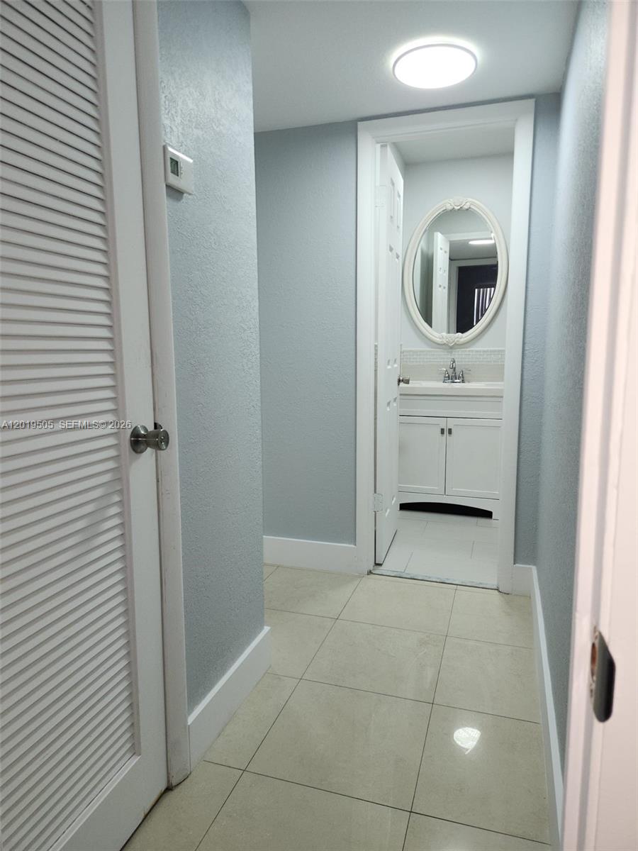 2811 North Pine Island Road, Unit 107 Sunrise, FL 33322 - Photo 10 of 16 a bathroom with a sink and a mirror