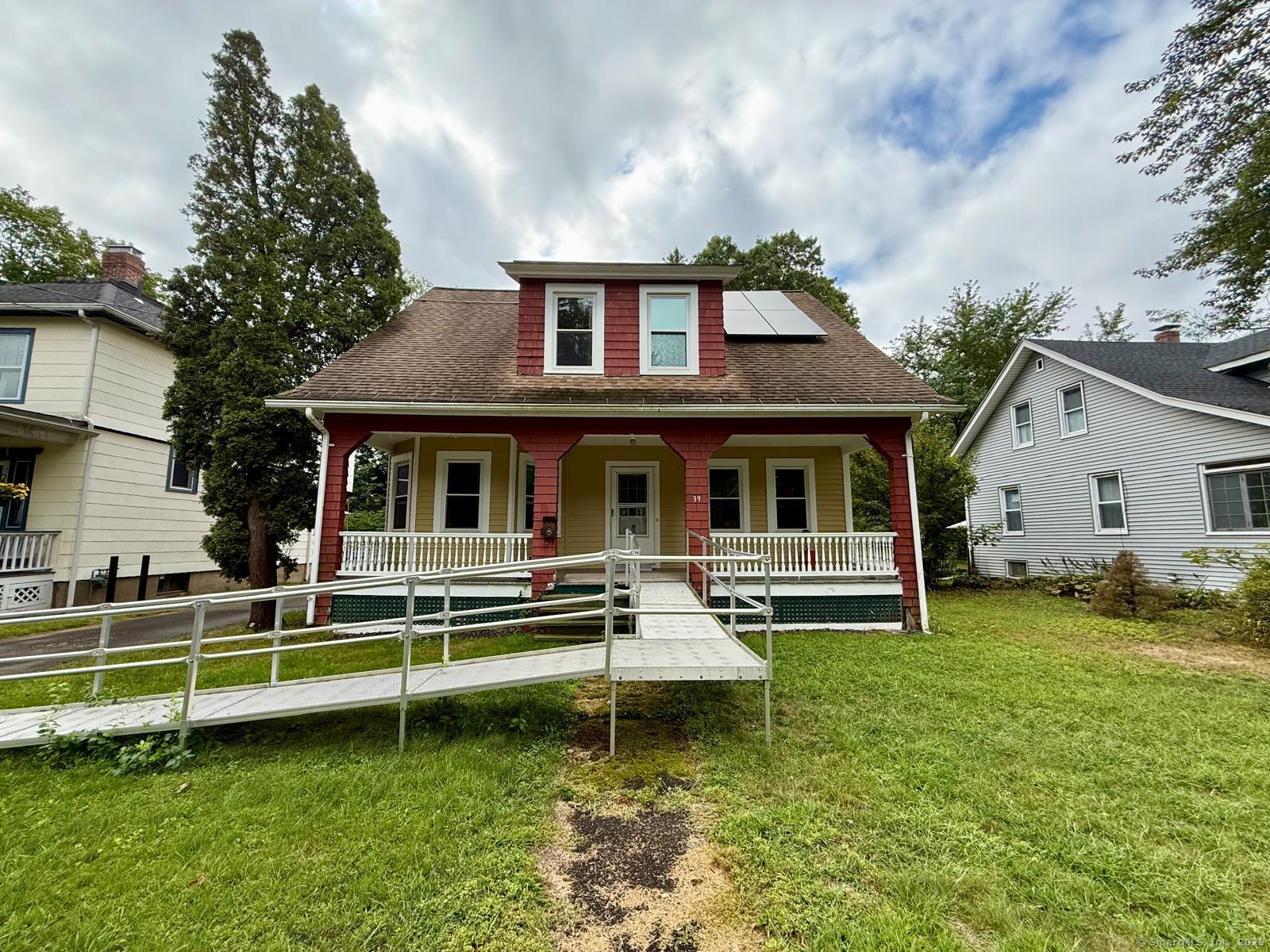 a front view of a house with a yard table and chairs