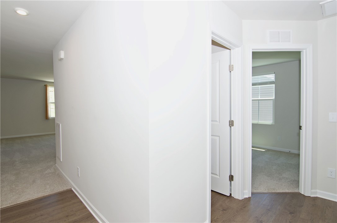 723 Peridot Way Westminster, SC 29693 - Photo 6 of 45 A pristine hallway welcomes with hardwood floors and pathways to sun-filled rooms.