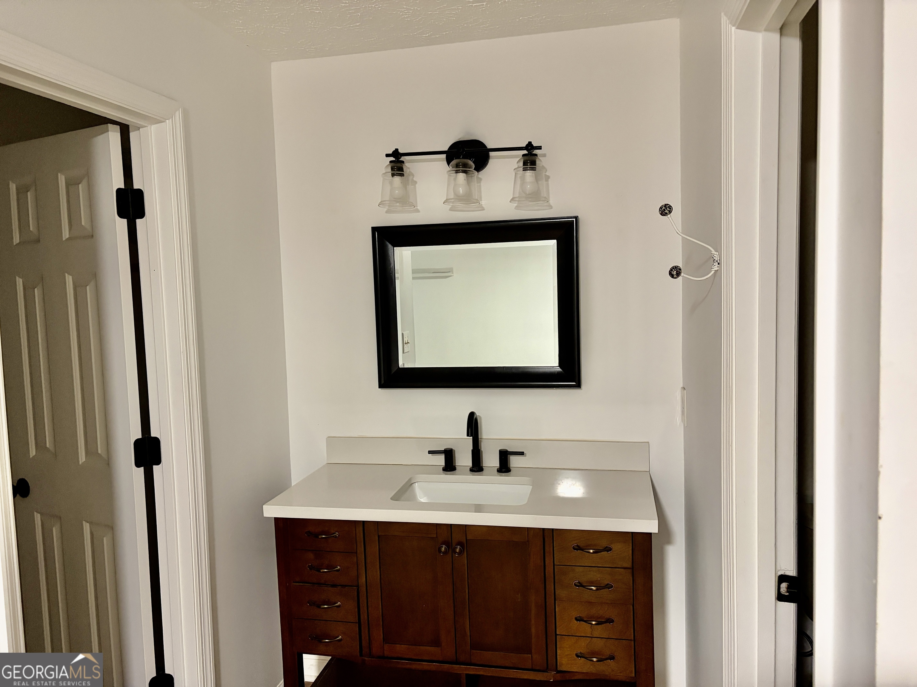 9 Argon Drive Northwest Rome, GA 30165 - Photo 11 of 14 a bathroom with a sink vanity and mirror