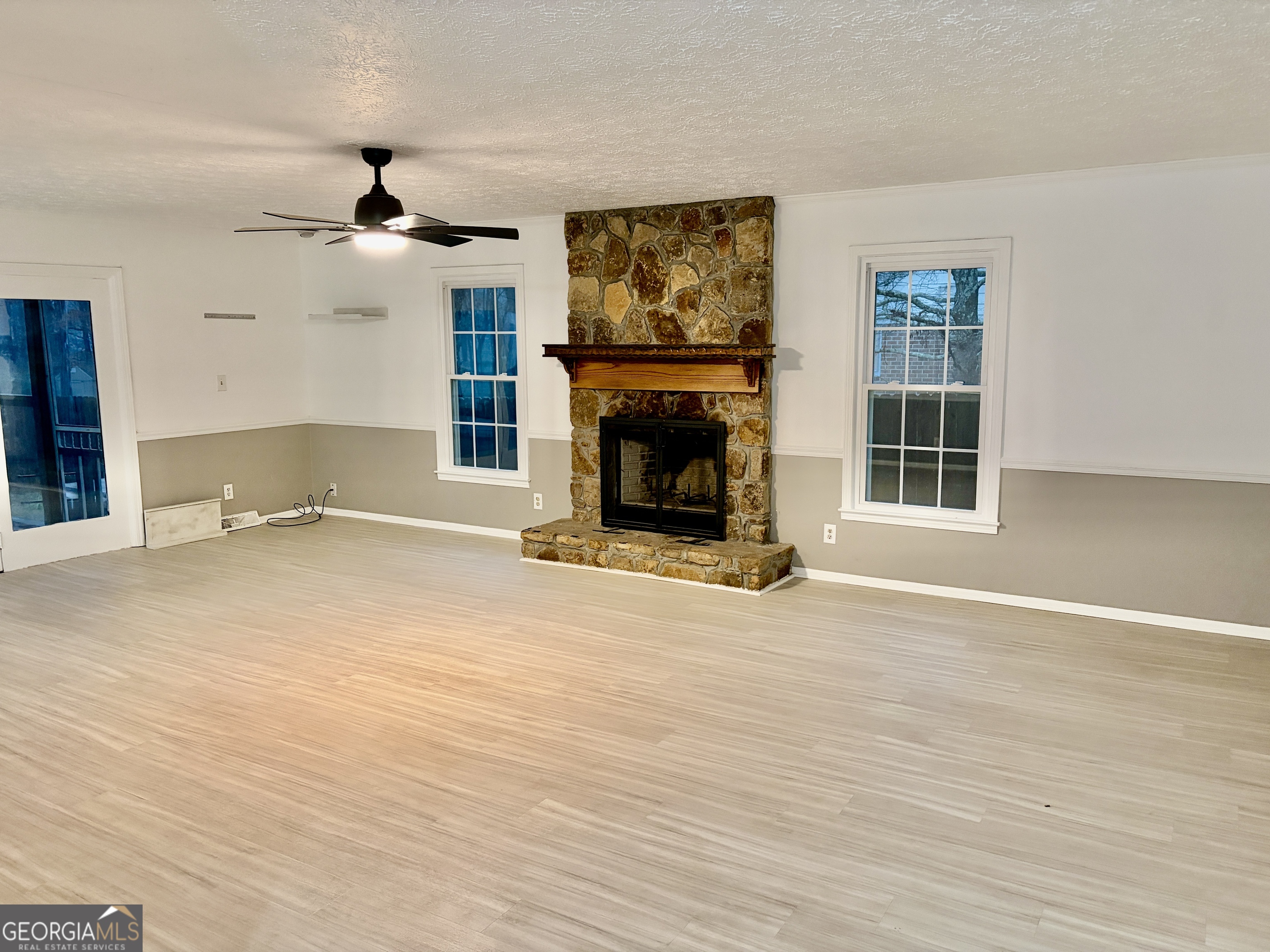 9 Argon Drive Northwest Rome, GA 30165 - Photo 5 of 14 a view of livingroom with fireplace chandelier and windows