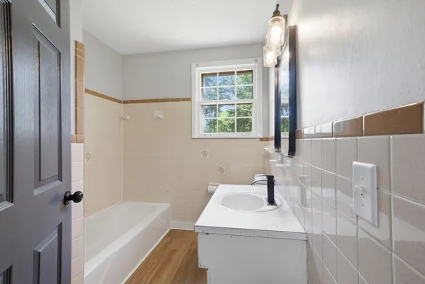 a bathroom with a sink a vanity and a mirror