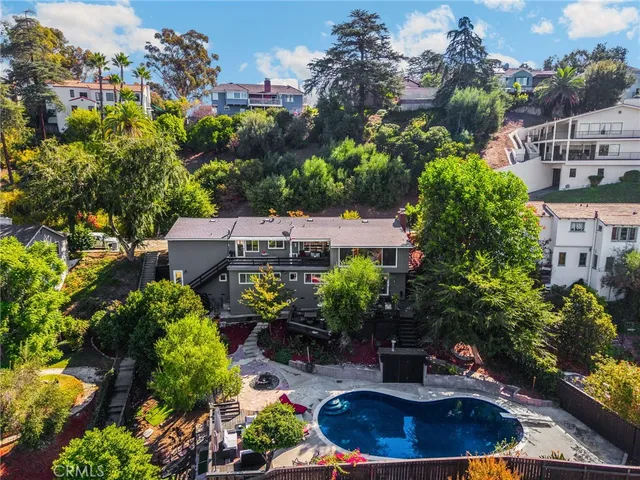 an aerial view of a house with yard and seating space