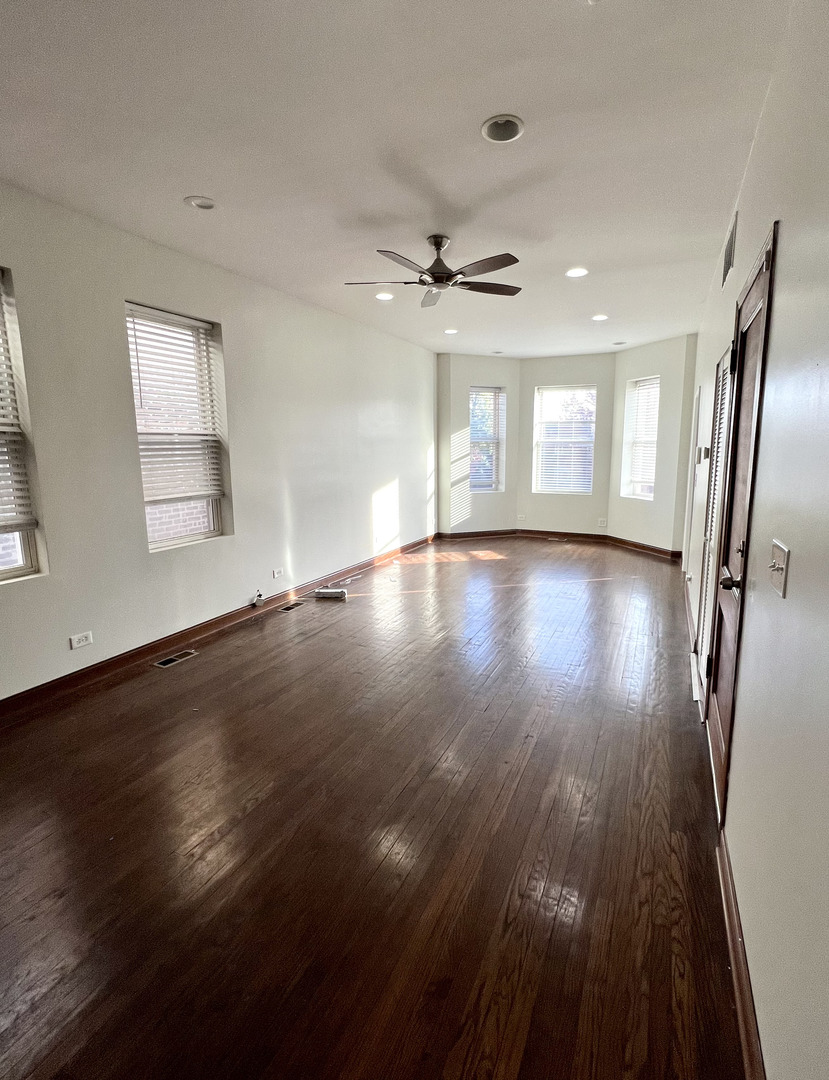 4116 West Cermak Road, Unit 2 Chicago, IL 60623 - Photo 2 of 10 a view of an empty room with wooden floor and a window