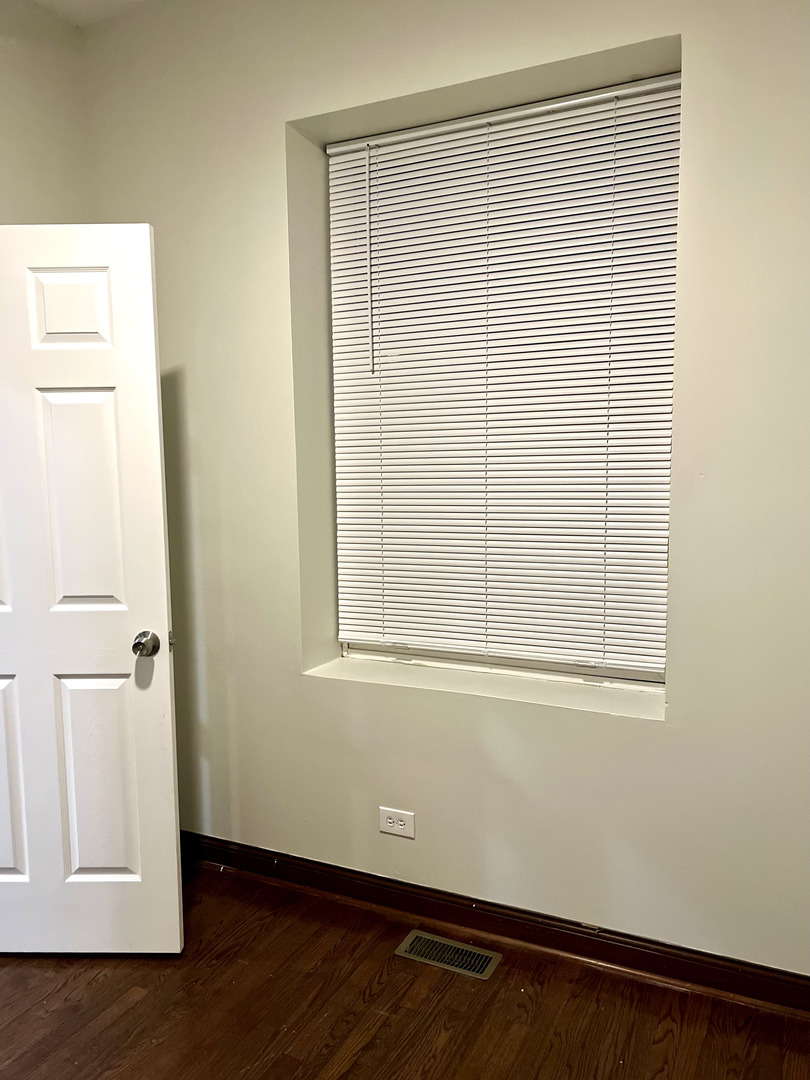 4116 West Cermak Road, Unit 2 Chicago, IL 60623 - Photo 6 of 10 an empty room with wooden floor and a window