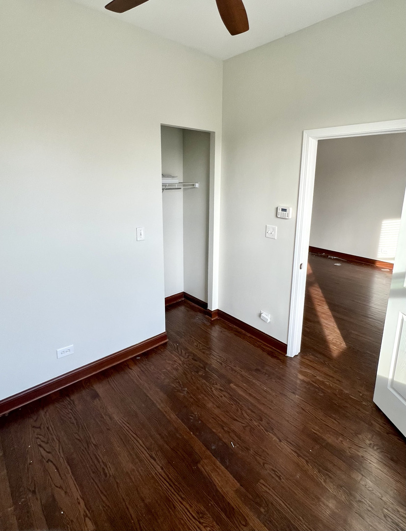 4116 West Cermak Road, Unit 2 Chicago, IL 60623 - Photo 7 of 10 a view of an empty room with wooden floor and a window