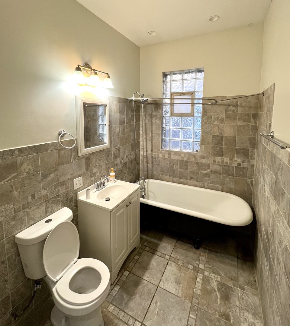 4116 West Cermak Road, Unit 2 Chicago, IL 60623 - Photo 9 of 10 a bathroom with a sink toilet and shower