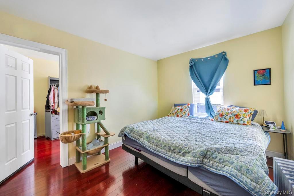 95-26 86th Street Queens, NY 11416 - Photo 16 of 28 Bedroom with a spacious closet and dark wood-type flooring