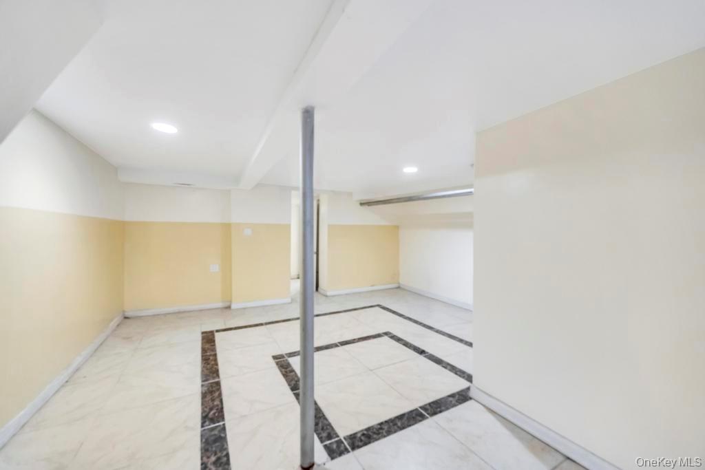 95-26 86th Street Queens, NY 11416 - Photo 26 of 28 Finished basement with baseboards and recessed lighting