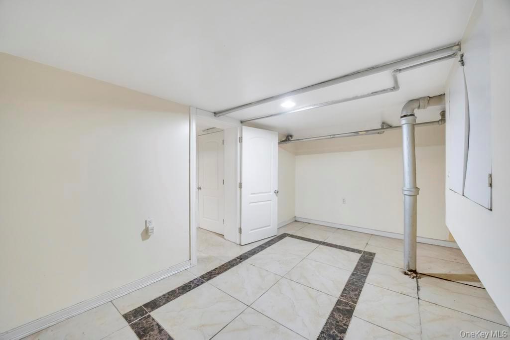 95-26 86th Street Queens, NY 11416 - Photo 28 of 28 Finished basement featuring baseboards