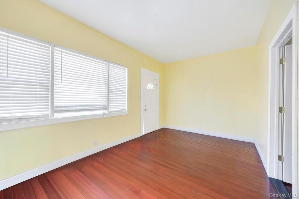 95-26 86th Street Queens, NY 11416 - Photo 6 of 28 Spare room featuring dark wood-style flooring and baseboards