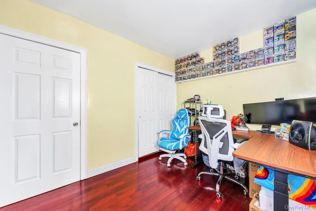 95-26 86th Street Queens, NY 11416 - Photo 9 of 28 Home office with dark wood-style flooring and baseboards