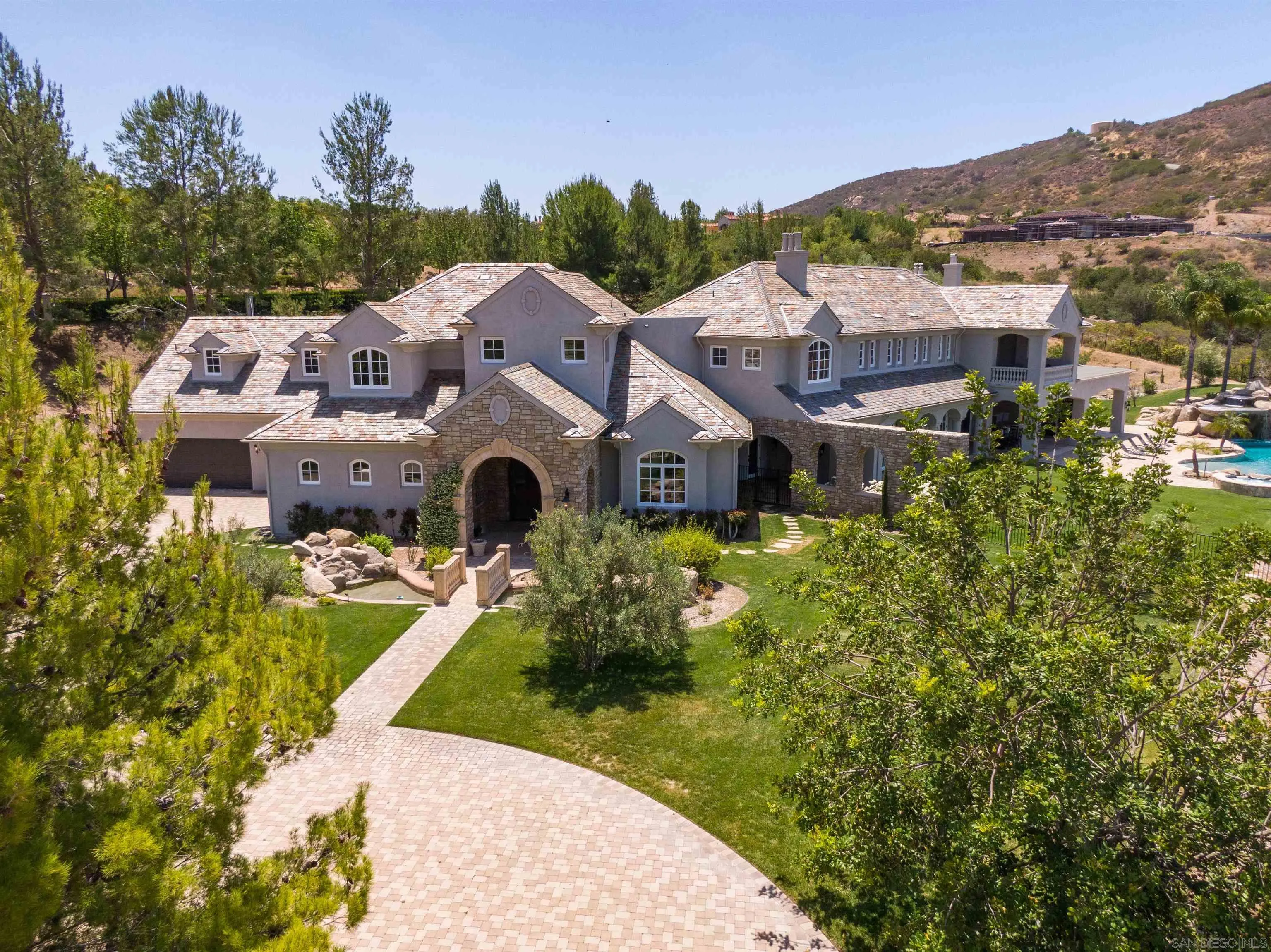 18781 Heritage Drive Poway, CA 92064 - Photo 1 of 69 a aerial view of a house with a big yard and potted plants