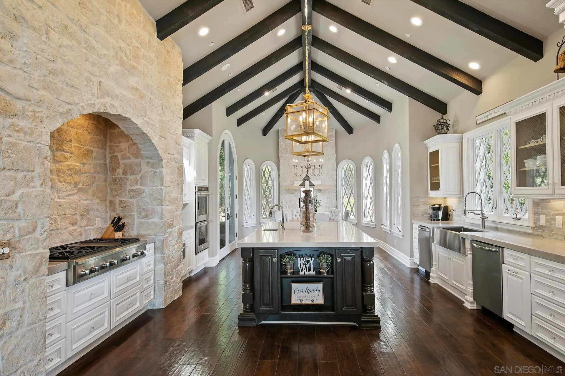 18781 Heritage Drive Poway, CA 92064 - Photo 14 of 69 a kitchen with stainless steel appliances kitchen island granite countertop a stove and white cabinets with wooden floor