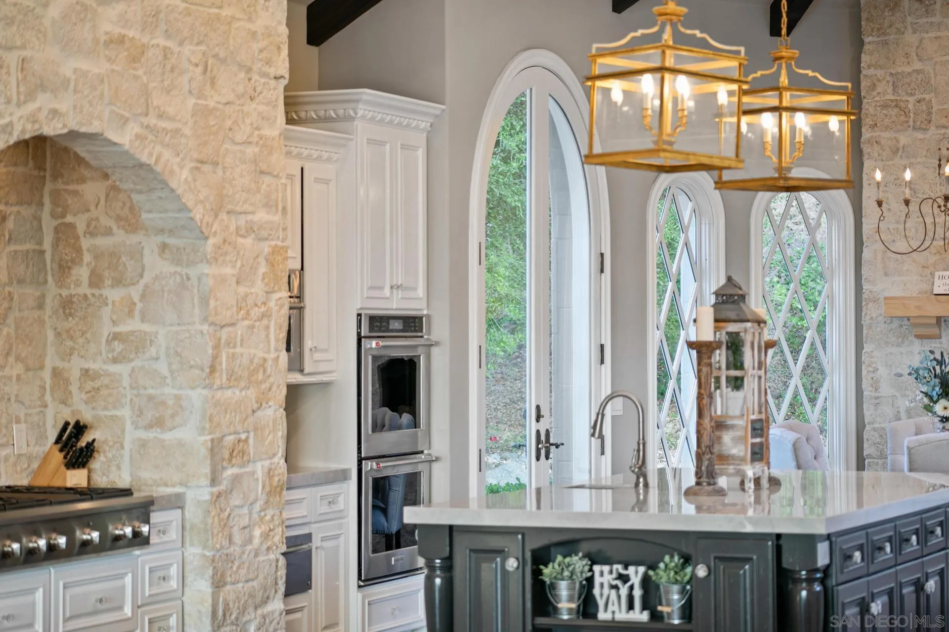 18781 Heritage Drive Poway, CA 92064 - Photo 16 of 69 a view of kitchen with granite countertop a stove a sink and a dining table next to a window