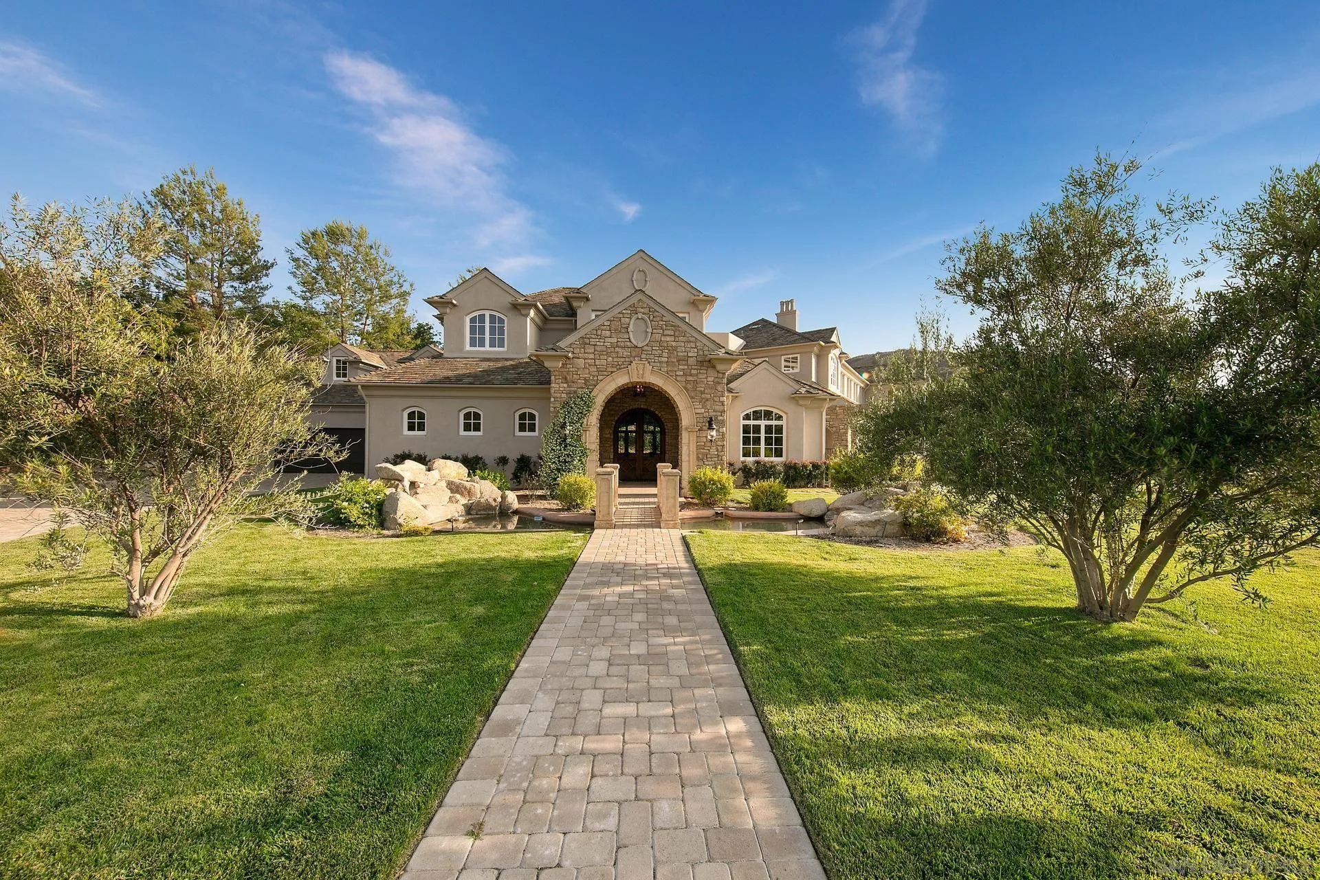 18781 Heritage Drive Poway, CA 92064 - Photo 2 of 69 a front view of a house with garden